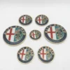 a2ae1feb-693c-4ec6-96aa-f3b6de2dc1ce.webp Kit de 7 emblèmes Alfa Romeo aux couleurs classiques avec bordure dorée